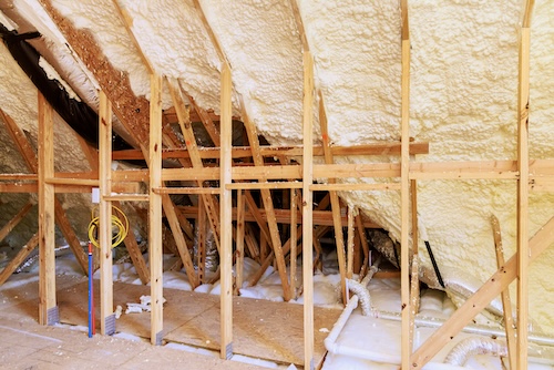 in progress spray foam insulation on underside of sloped roof
