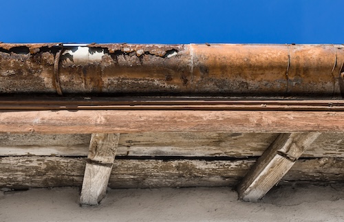 steel gutters on old house showing chipped rust