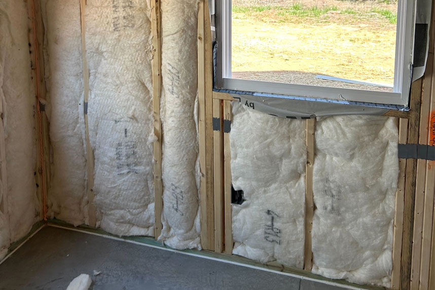Ceiling and window framing with insulation tucked between joists