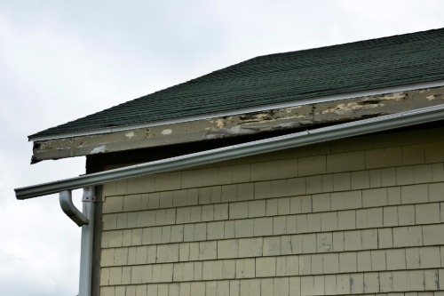 

A badly damaged gutter on a house side.
