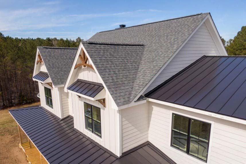 Sunny Daytime Drone Images of a Custom Home in the Final Stages of Construction. It Features a Roof With Architectural Asphalt Shingles and Standing Seam Accents.